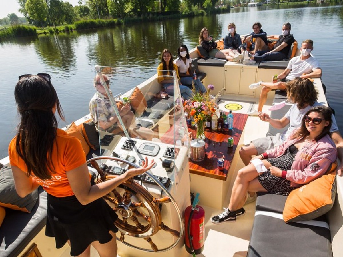 a group of people sitting in a boat on a body of water